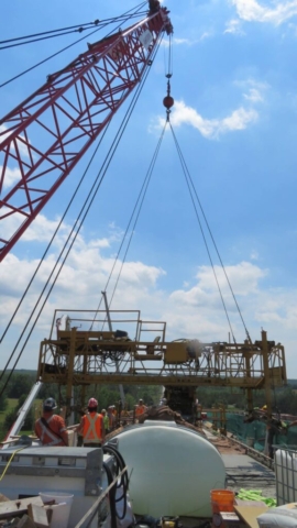 110-ton crane starting to lift the concrete finisher from the deck
