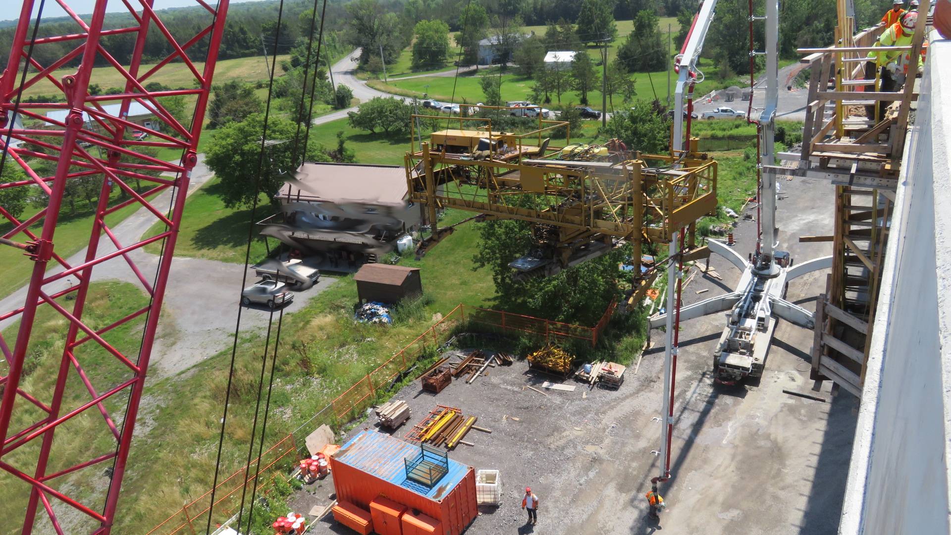 110-ton crane starting to lower the concrete finisher