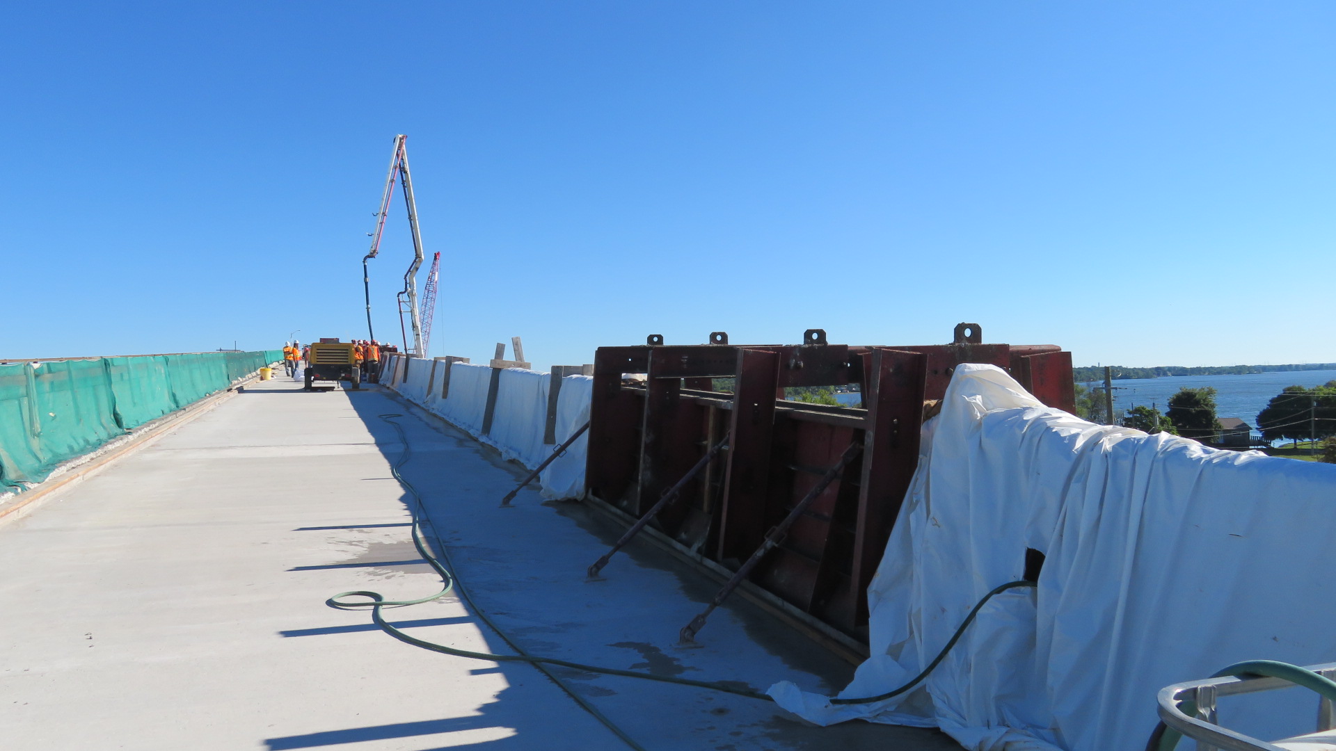 View north, completed section of concrete barrier wall and barrier wall forms