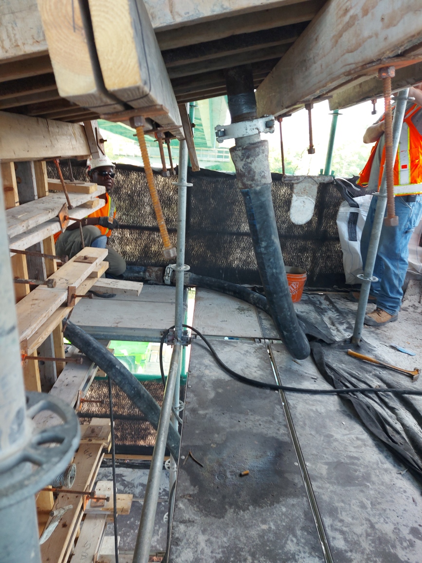 Concrete hose connected to the formwork for placement