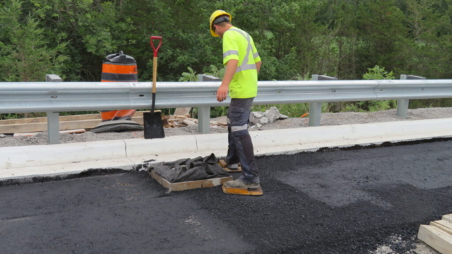 Tamping down the newly placed asphalt