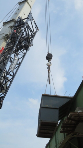 160-ton crane holding containment bin during demolition