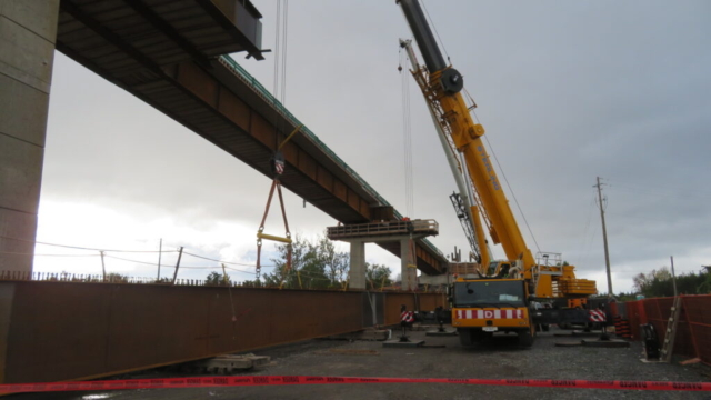 200 and 160 ton cranes starting to lift the third girder