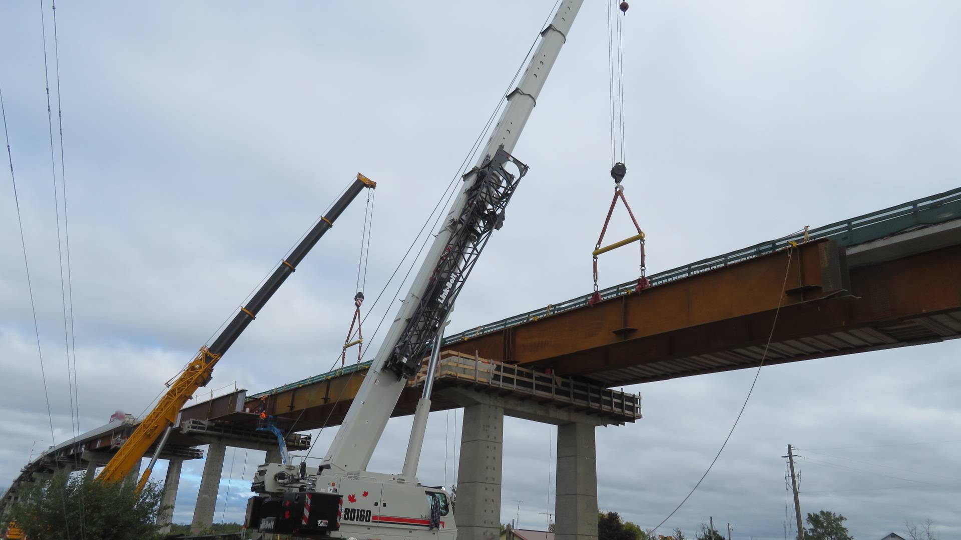 200 and 160 ton cranes, installing the third girder
