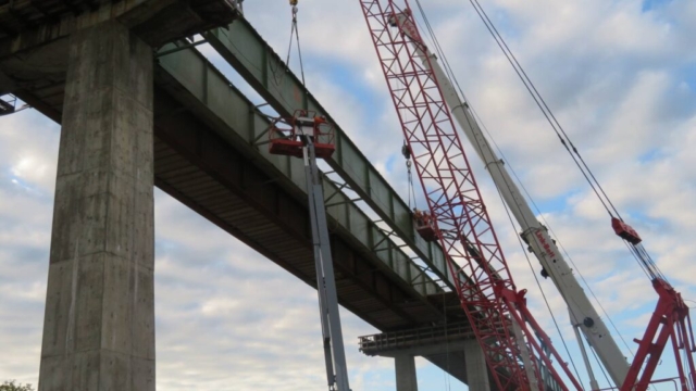 160 and 110-ton cranes, hooked-up to the girder section