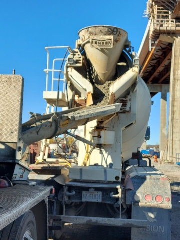 Concrete truck filling the concrete pump