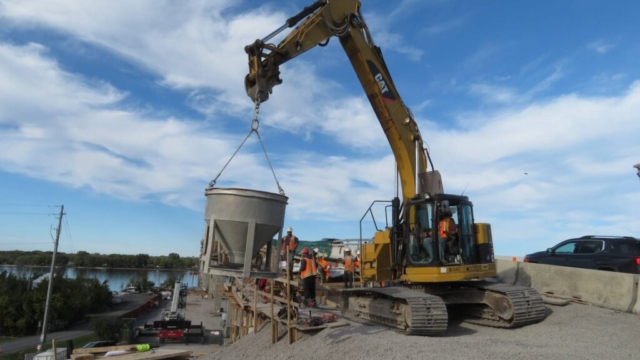 Using the excavator to move the concrete hopper