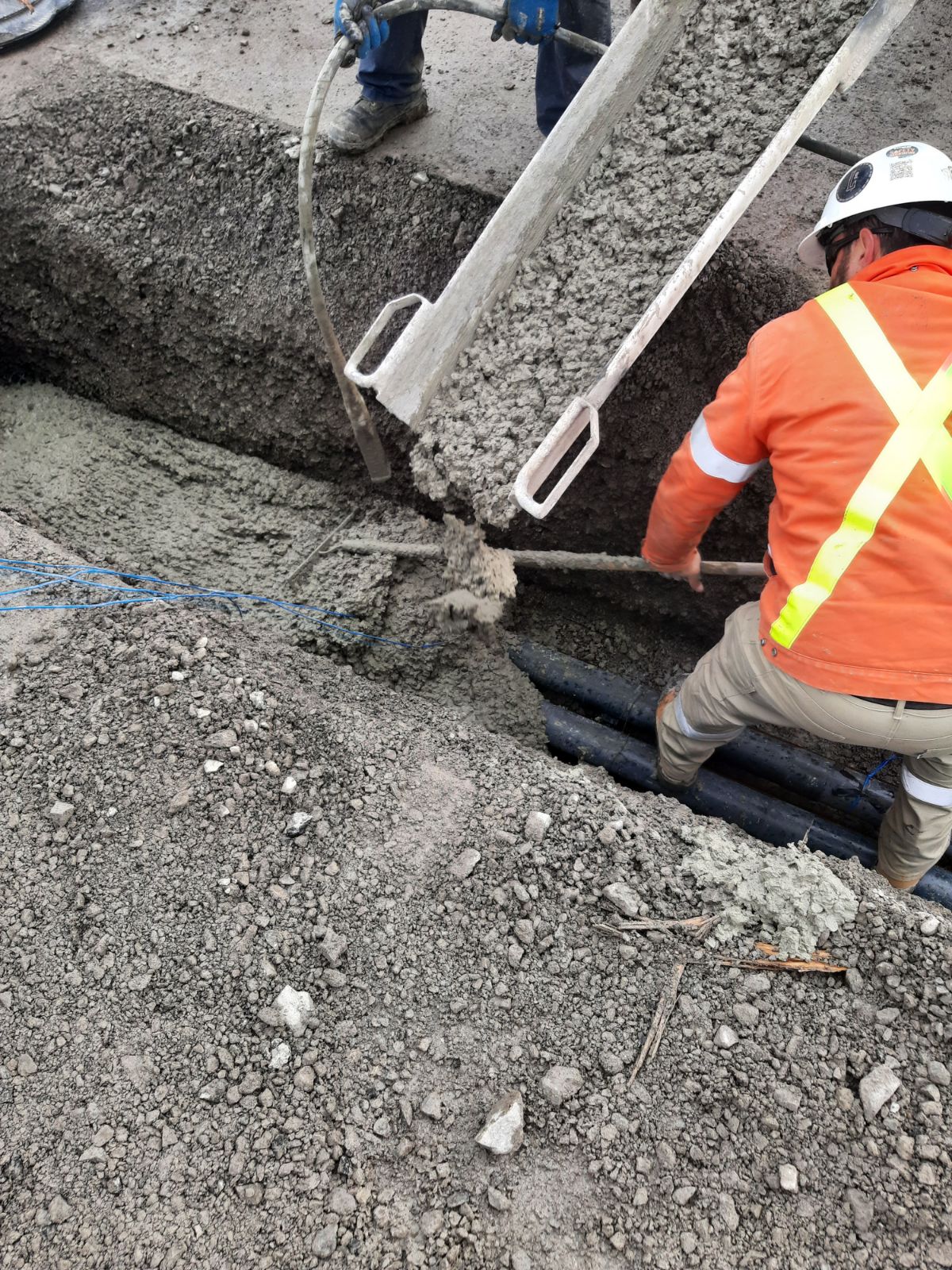Placing concrete in the electrical conduit trench