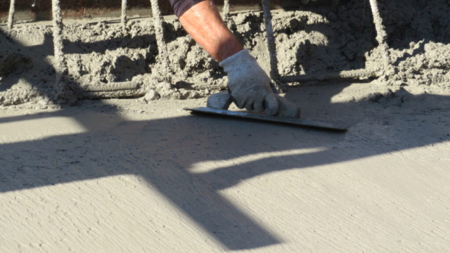 Hand finishing the edges of the concrete deck