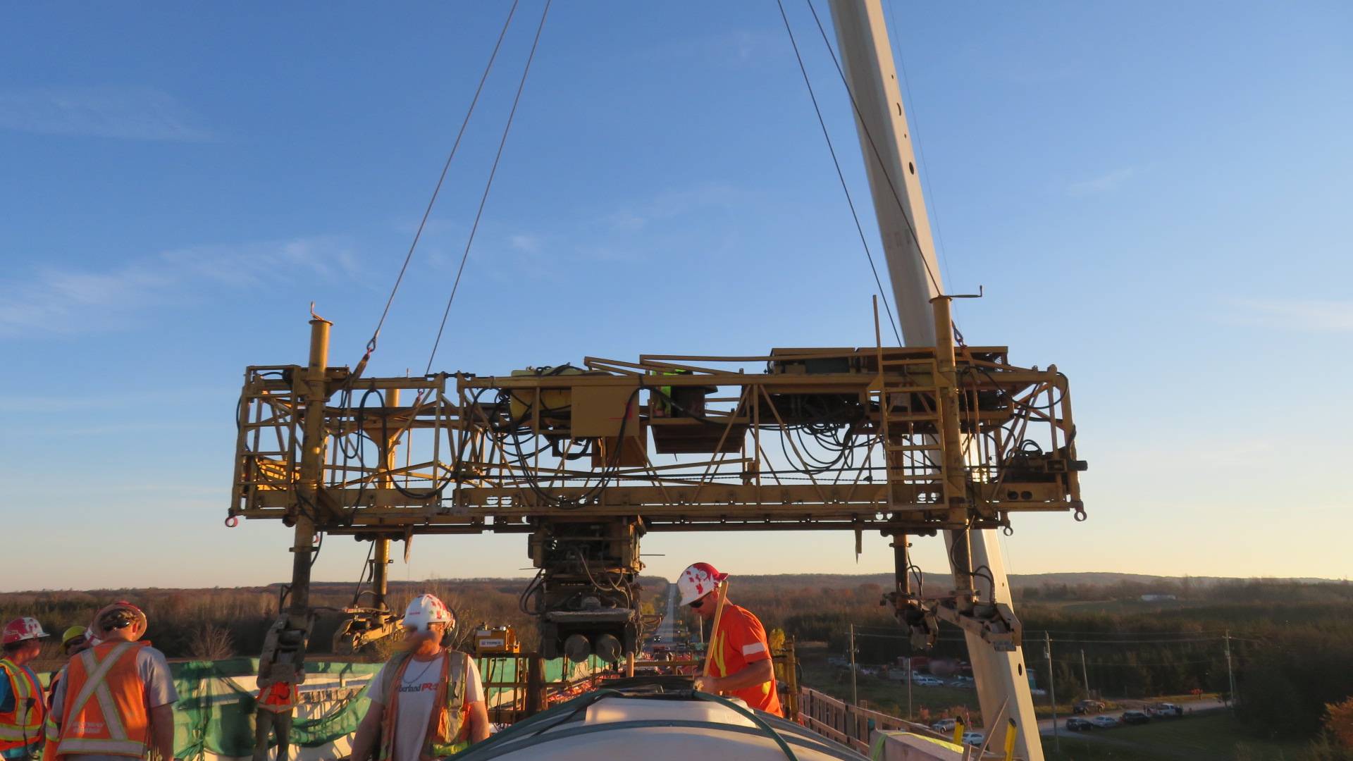 160-ton crane starting to lift the concrete finisher from the bridge deck