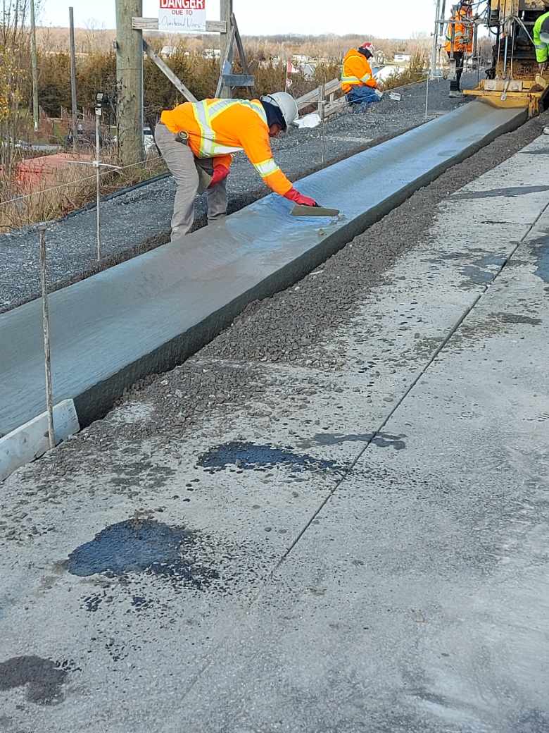 Finishing the curb and gutter concrete