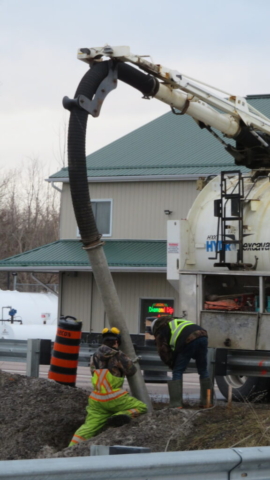 Vacuum truck being used to prepare for light pole installation