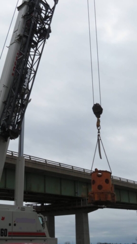 Lifting the rotary head attachment to the bridge deck