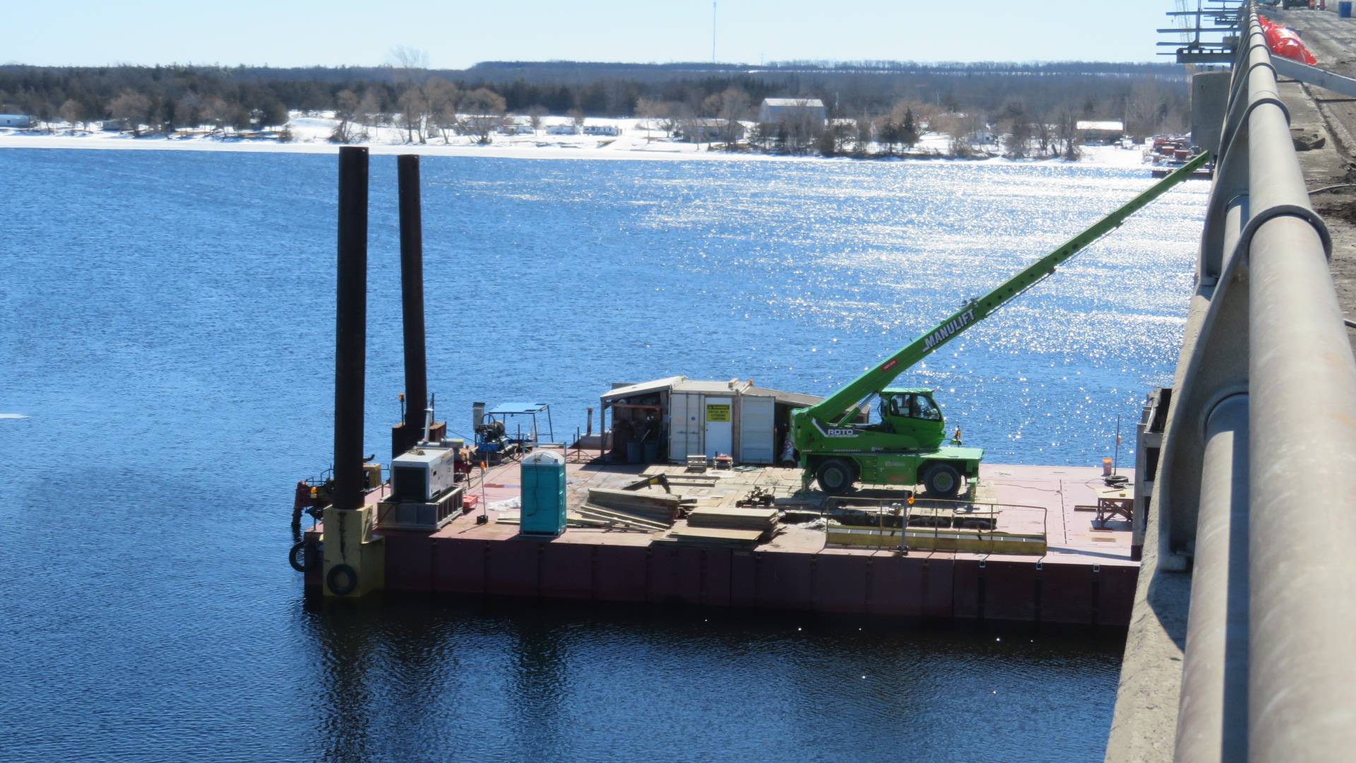 Manlift on the barge removing / installing false decking