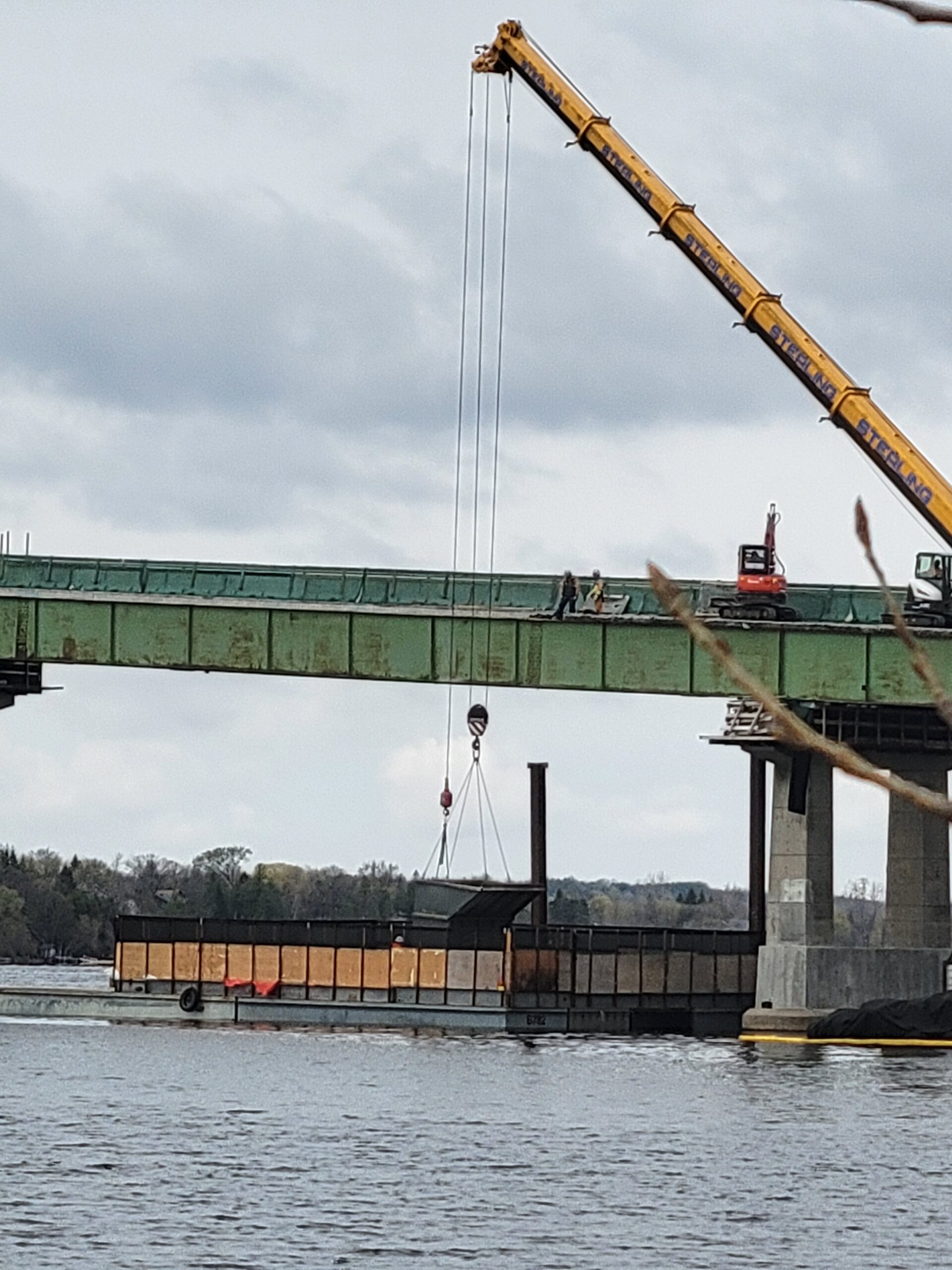 360-ton crane lifting the containment bin from the barge