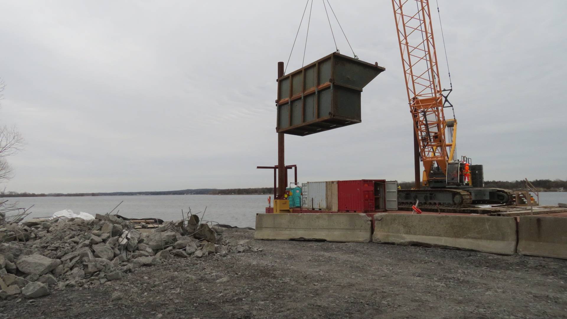 200-ton crane lowering the containment bin to the shore