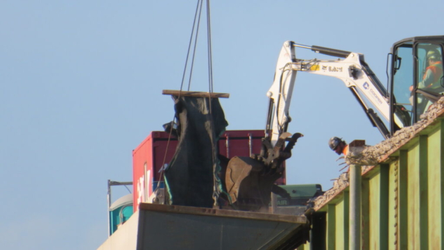 Removing deck debris to the containment bin