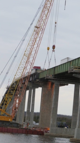 200-ton cranes, torch cutting the first girder section for removal