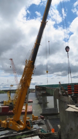 360 and 200-ton cranes hooked up to the final girder section for removal
