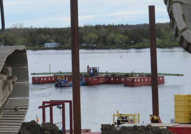 Using the barge to move the removed girder to the dock