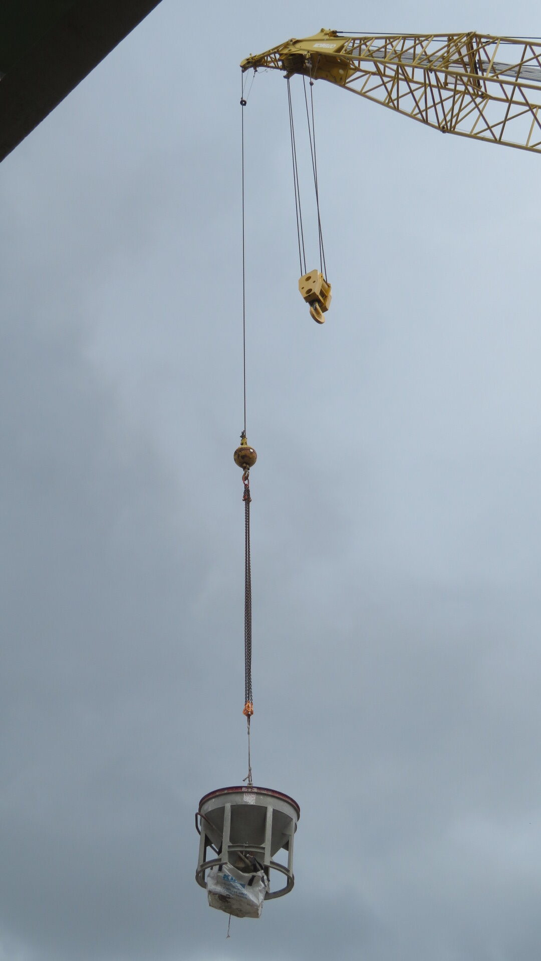 200-ton crane lifting the full concrete hopper to the pier cap