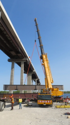 200-ton crane preparing to lower the girder onto the barge