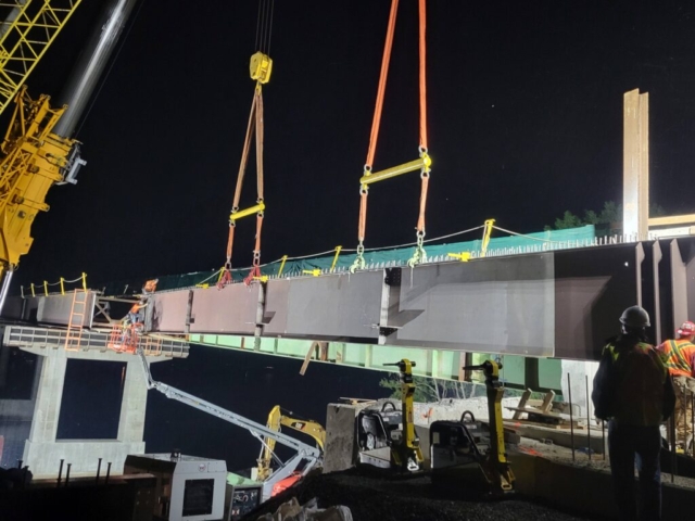 Lowering the girder into place