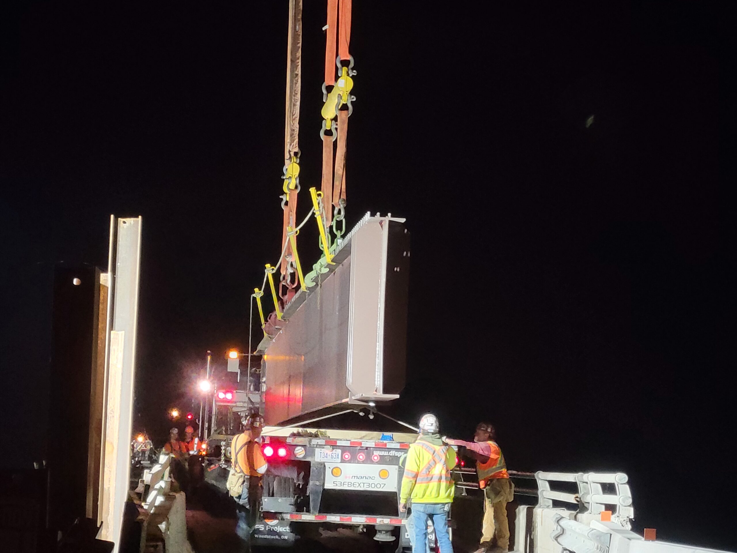 Starting to lift the second girder from the truck