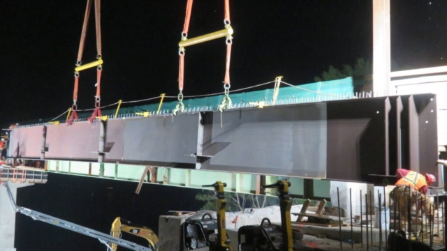 Close-up, lowering the first girder