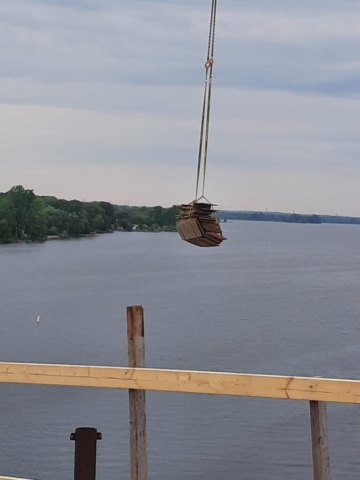 200-ton crane lifting lumber to the bridge deck
