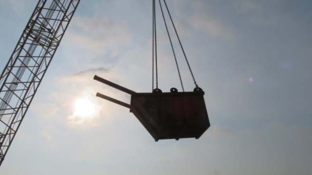 200-ton crane removing the bin of removed pipe from the bridge deck