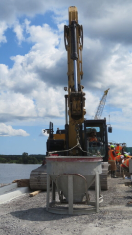 Excavator and hopper, preparing to place approach slab