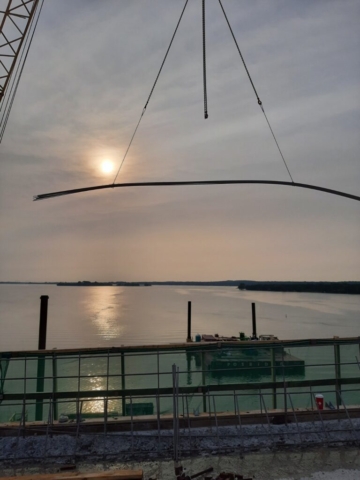 200-ton crane lifting rebar to the bridge deck