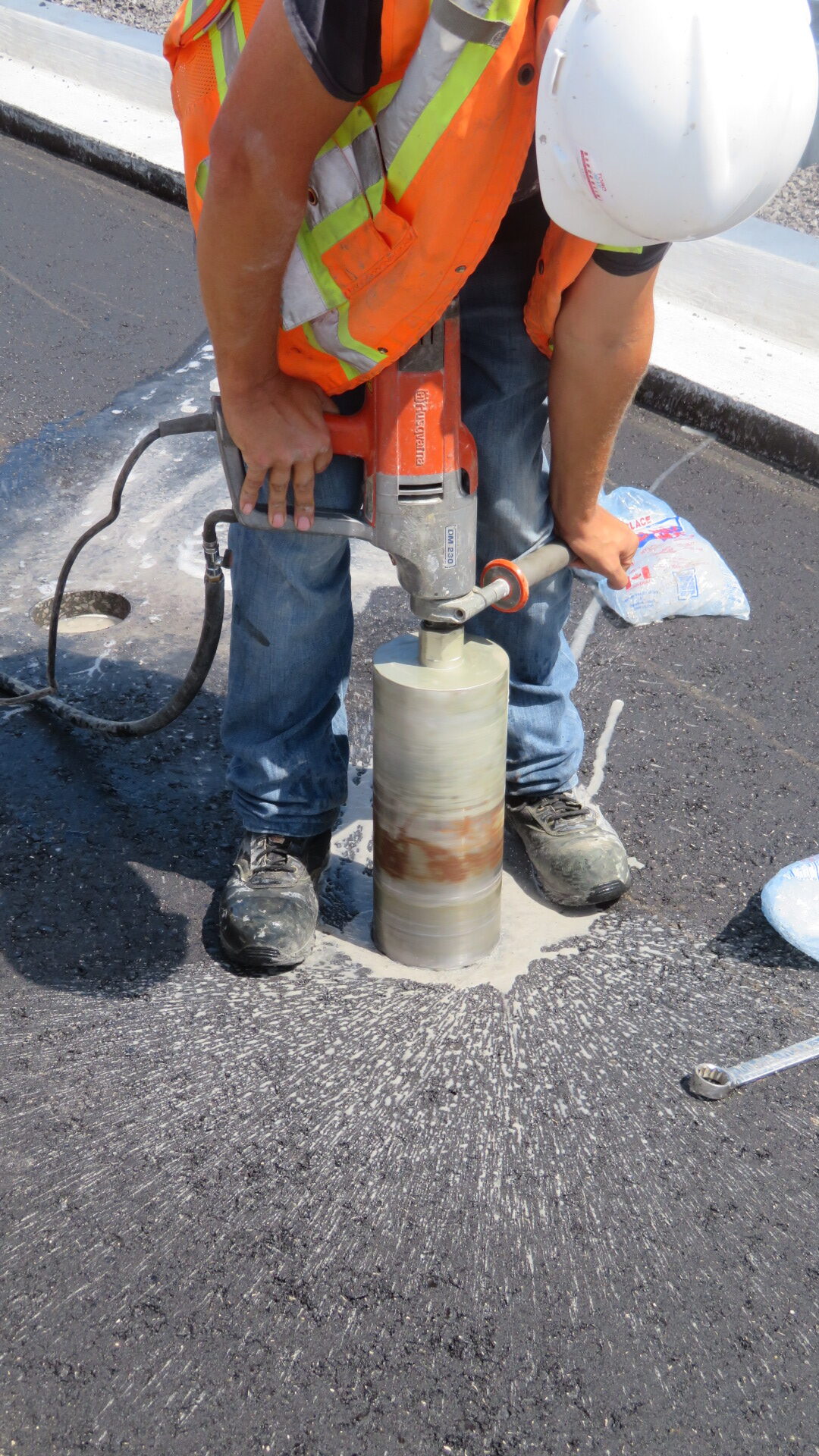 Taking a core sample of the new asphalt