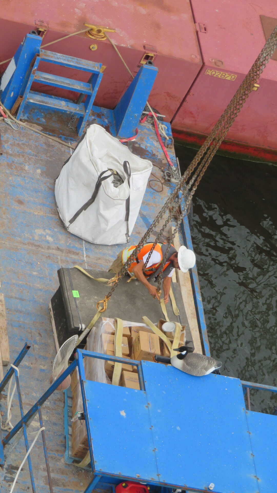 Hooking the protection boards to the crane to be lifted from the boat