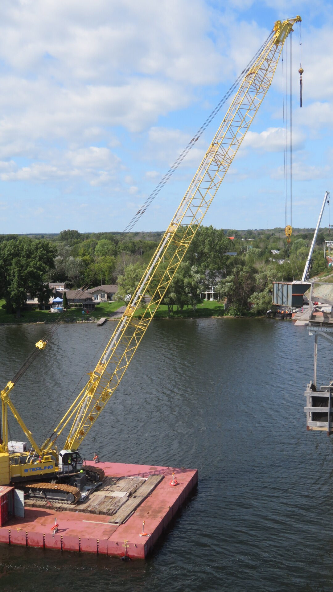 200-ton crane lifting the containment bin to the barge